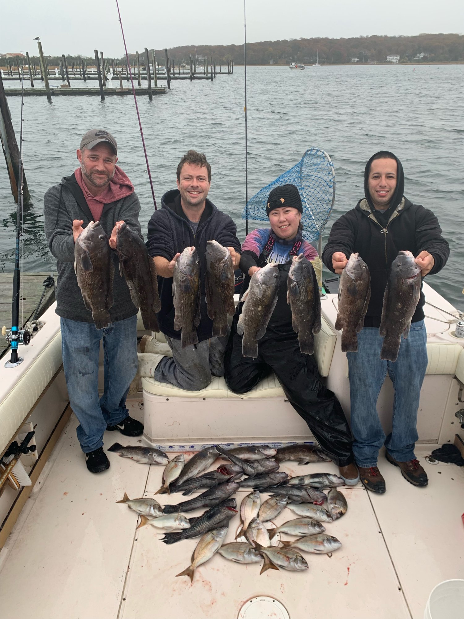 Four anglers with a full haul of blackfish, sea bass and porgies on a fall charter out of Mount Sinai
