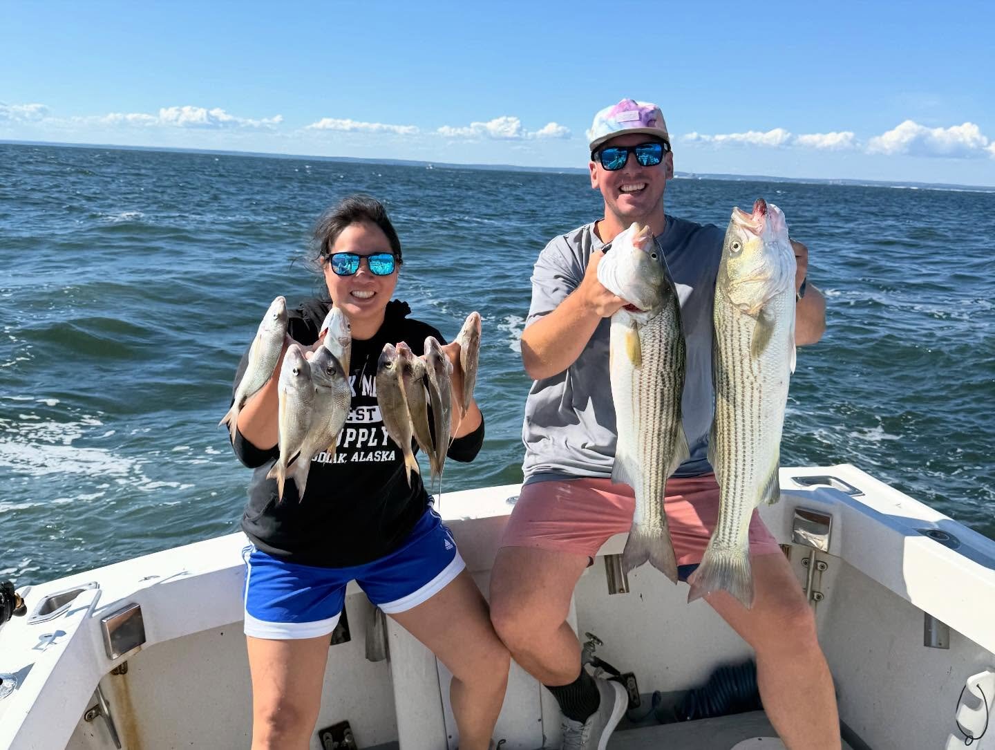 Couple on board the Christina M II with a mixed bag of porgies and striped bass